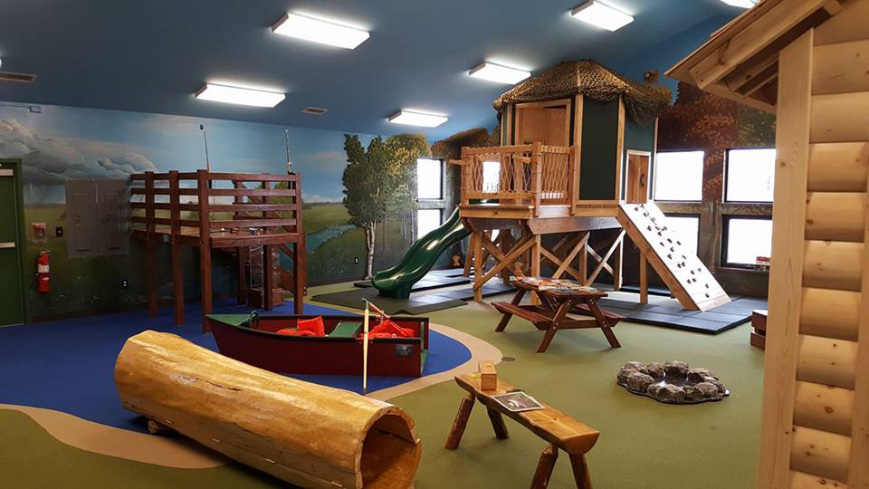 an indoor play area that replicates the great northwoods for kids to play on